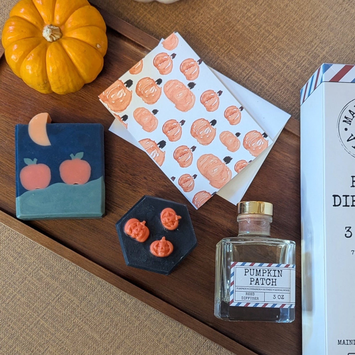 Decorative items with pumpkin designs on a wooden surface