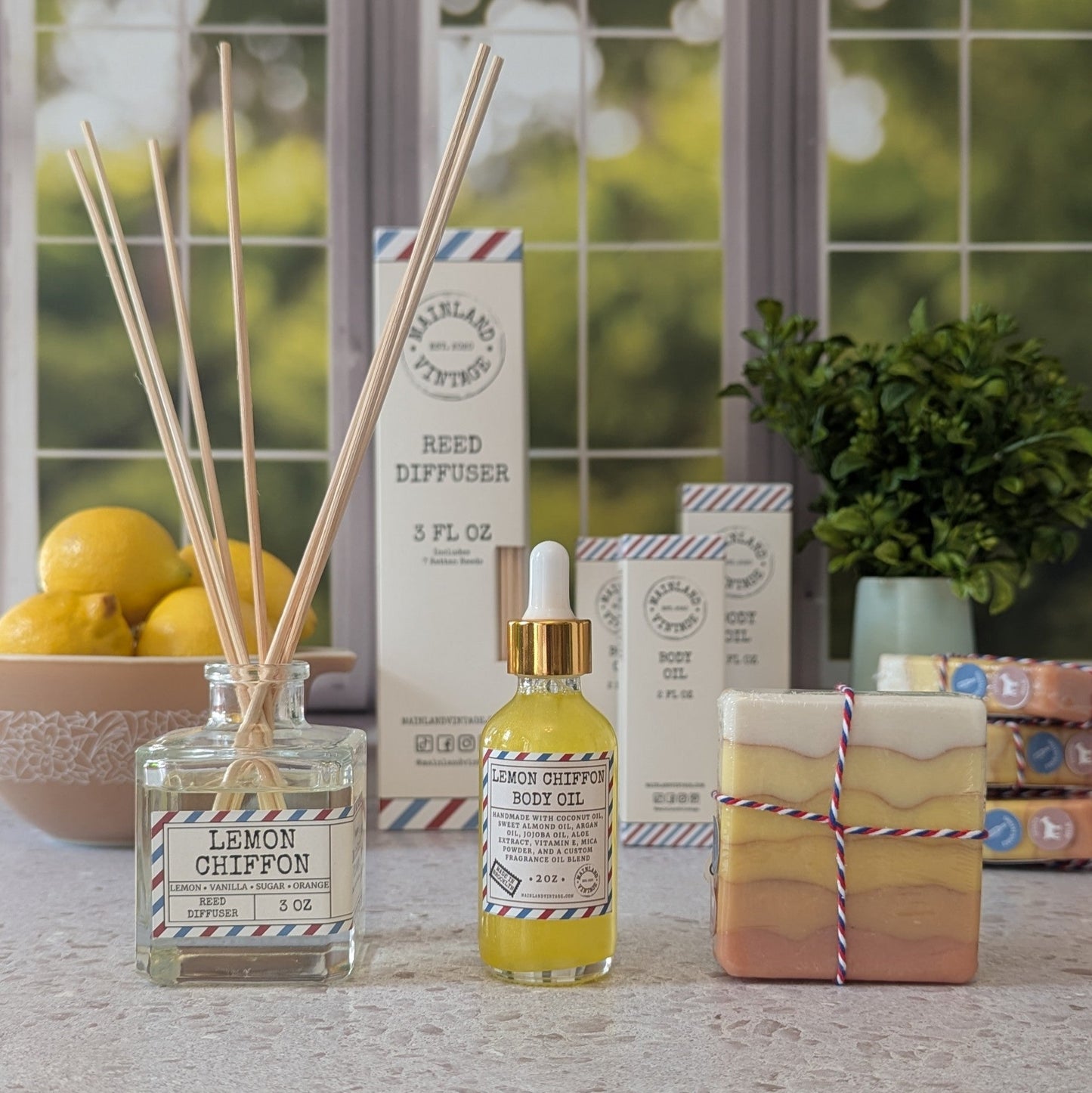 Lemon Chiffon diffuser set with reed diffuser, bottle, and soap on a surface.
